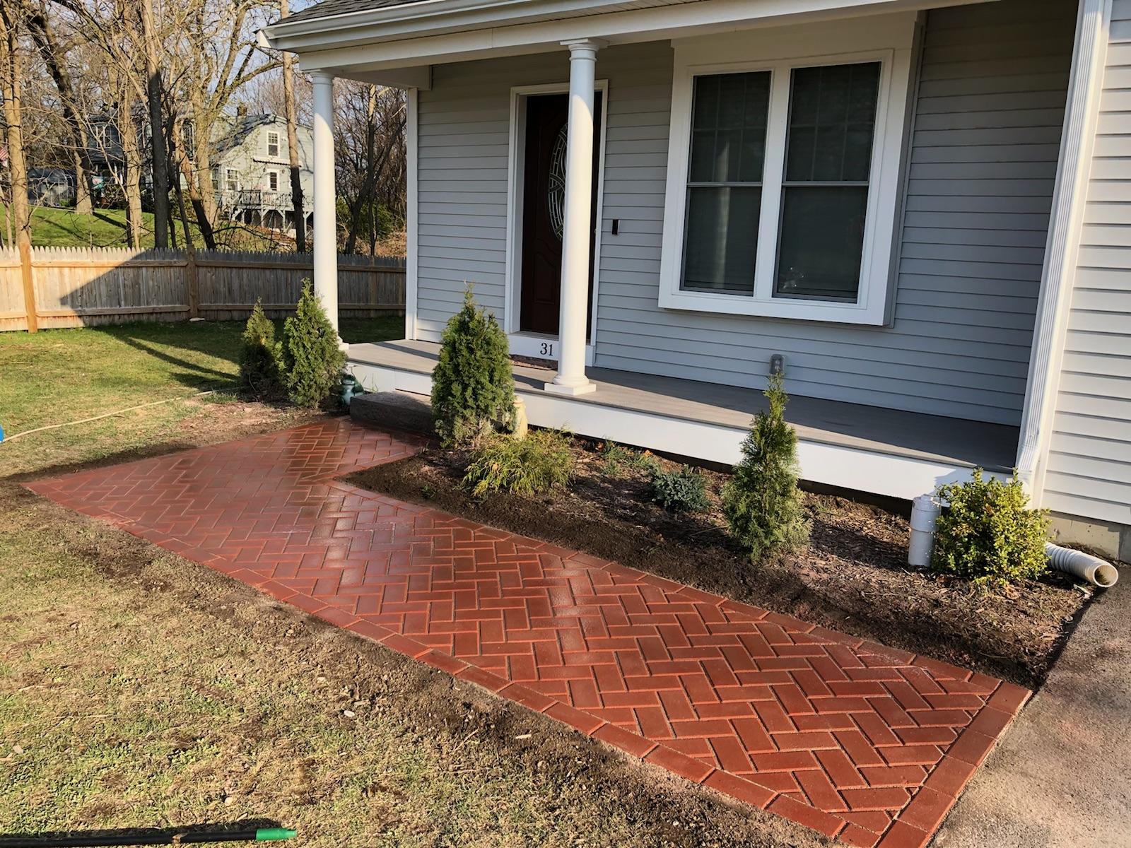 Herringbone red paver walkway at a Foxboro, MA home entry — Mass Patio & Masonry