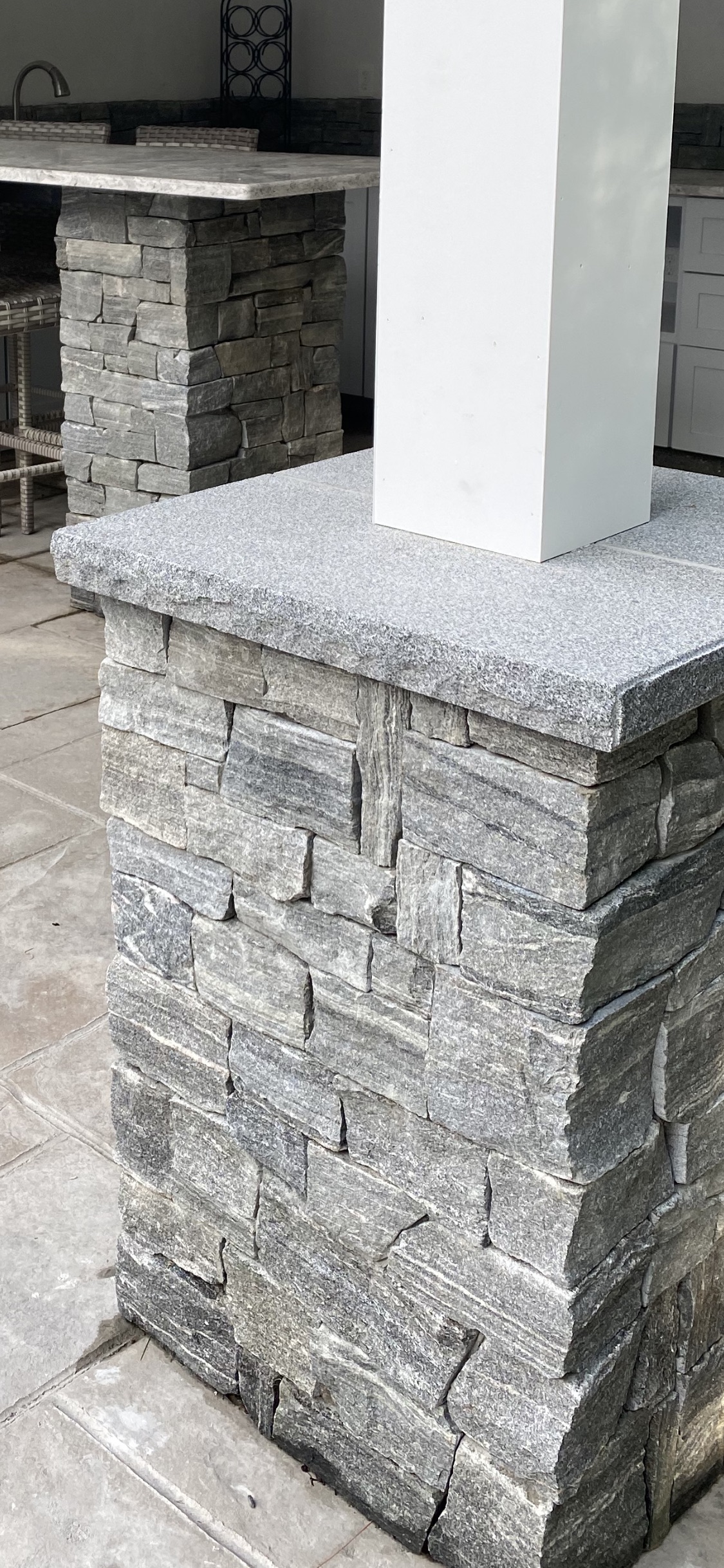 Veneer stone and granite pillar feature on a pool cabana in Easton, MA — Mass Patio & Masonry